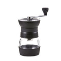 Hario Skerton Pro ceramic coffee mill with hand crank and glass container for fresh coffee grounds.